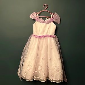 Beautiful white flower girl dress with lilac flowers.